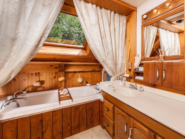 full bathroom featuring a garden tub and vanity