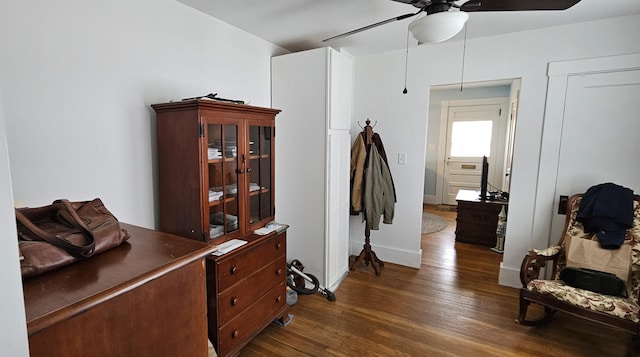interior space featuring baseboards and dark wood-style floors