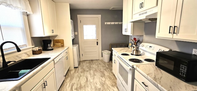 kitchen with white cabinets, a sink, white appliances, radiator, and under cabinet range hood