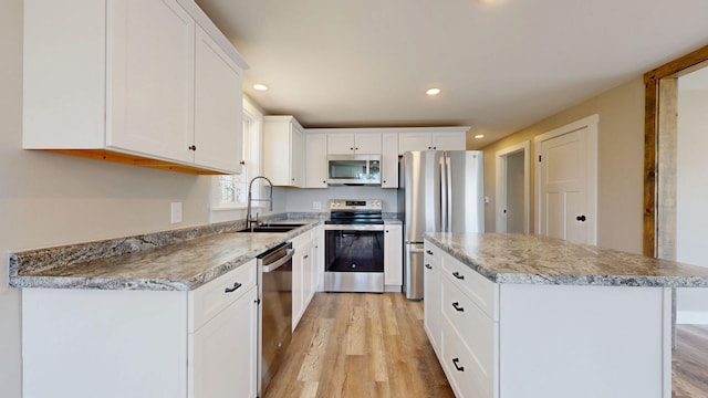 12 Marble Ln, Dixfield, ME 04224 - kitchen with appliances with stainless steel finishes, a sink, light wood-style floors, a center island, and recessed lighting
