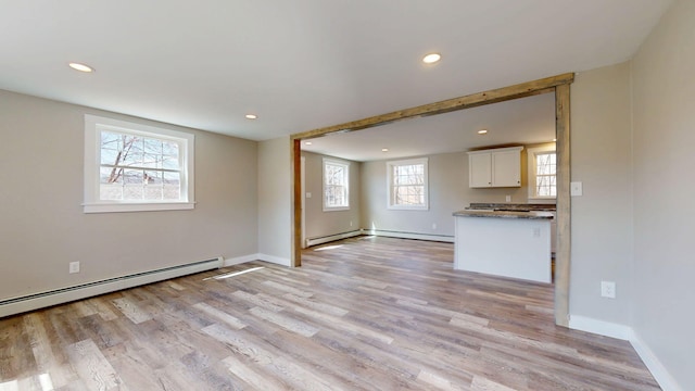 12 Marble Ln, Dixfield, ME 04224 - unfurnished living room with light wood finished floors, a baseboard radiator, recessed lighting, and baseboards