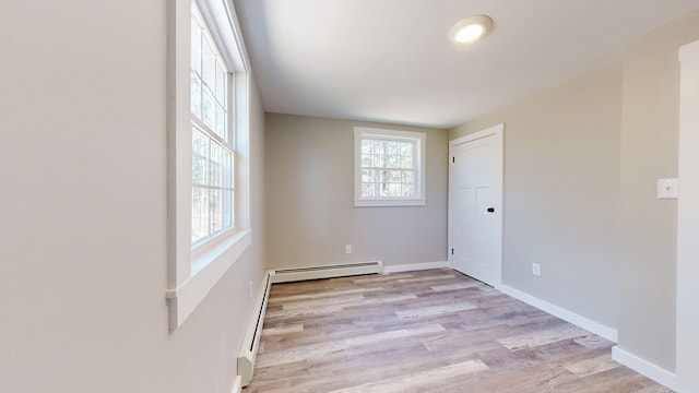 12 Marble Ln, Dixfield, ME 04224 - empty room featuring a baseboard heating unit, light wood-type flooring, and baseboards