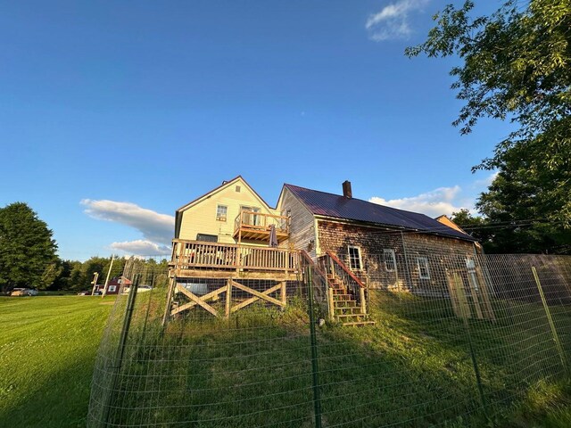 344 Main St, Lincoln, ME 04457 - back of house featuring metal roof, a chimney, a wooden deck, stairway, and a yard