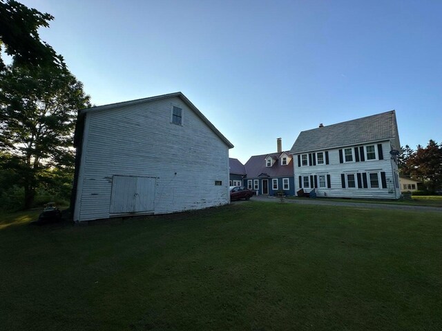 344 Main St, Lincoln, ME 04457 - rear view of house featuring a lawn
