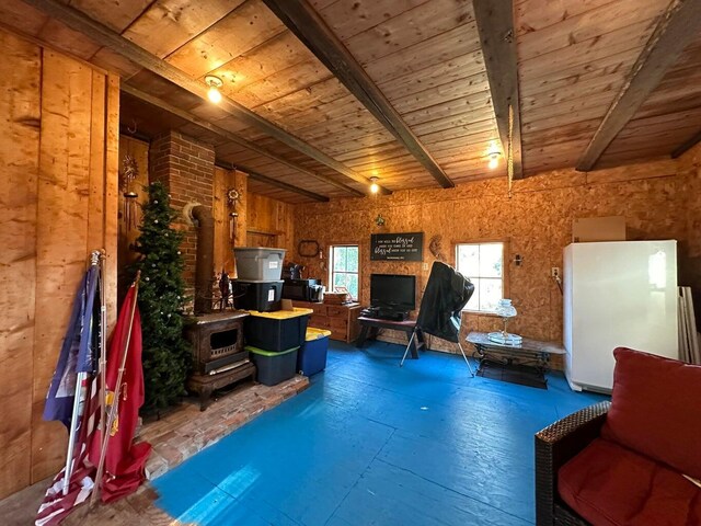 344 Main St, Lincoln, ME 04457 - living area with beamed ceiling, wood ceiling, and a wood stove