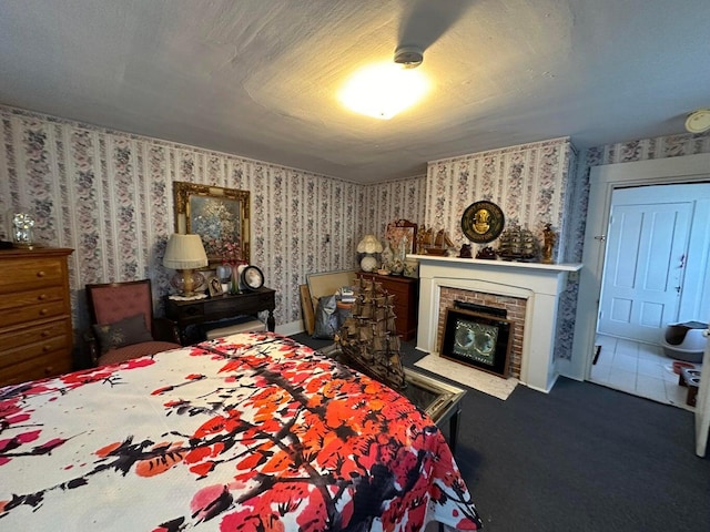 344 Main St, Lincoln, ME 04457 - bedroom with a brick fireplace, wallpapered walls, and carpet flooring