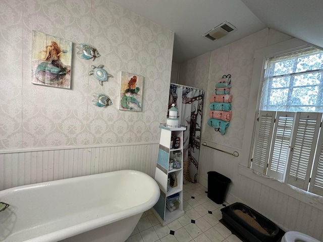 344 Main St, Lincoln, ME 04457 - bathroom featuring wallpapered walls, visible vents, lofted ceiling, and tile patterned flooring