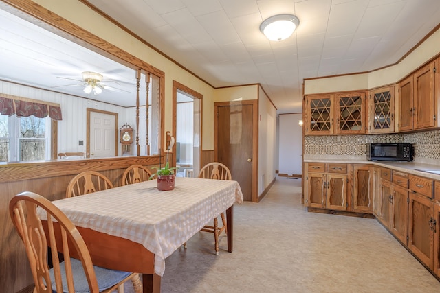 dining space with ornamental molding and ceiling fan