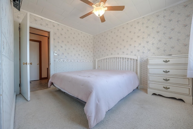 carpeted bedroom featuring crown molding, a ceiling fan, and wallpapered walls