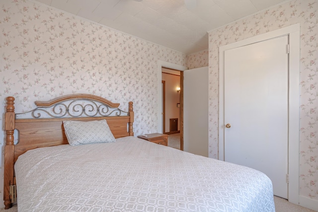 bedroom with ornamental molding, carpet, and wallpapered walls