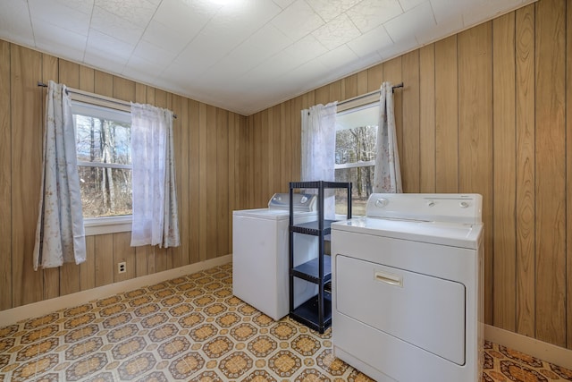 laundry area with independent washer and dryer, laundry area, a wealth of natural light, and light floors
