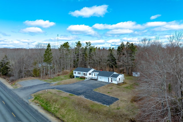 aerial view featuring a wooded view