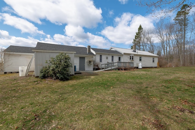 back of house with a yard and a deck