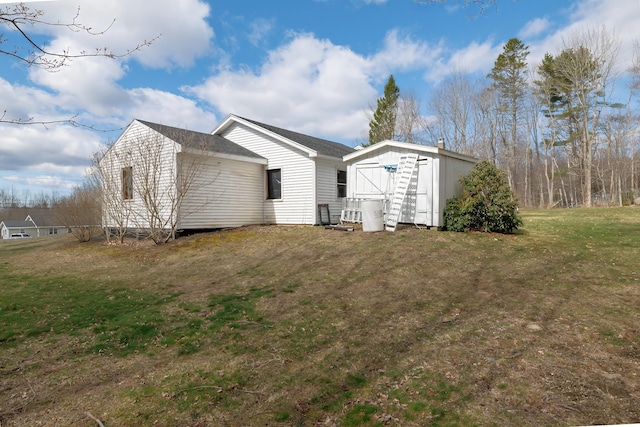 view of side of property with a storage unit, an outdoor structure, and a yard