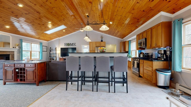 kitchen featuring appliances with stainless steel finishes, open floor plan, wooden ceiling, dark countertops, and baseboard heating