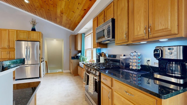 kitchen featuring ornamental molding, wood ceiling, dark stone countertops, vaulted ceiling, and stainless steel appliances