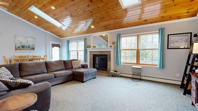 carpeted living area with a skylight, a baseboard heating unit, wooden ceiling, vaulted ceiling, and a tiled fireplace