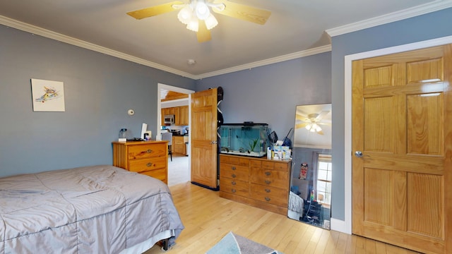 bedroom featuring wood finished floors, crown molding, and a ceiling fan
