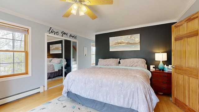 bedroom featuring a baseboard radiator, light wood-type flooring, multiple windows, and crown molding