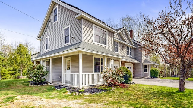 view of front facade featuring a porch, asphalt driveway, a front lawn, a chimney, and a garage