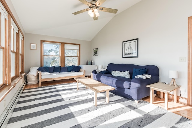 living area featuring a ceiling fan, vaulted ceiling, baseboard heating, and wood finished floors
