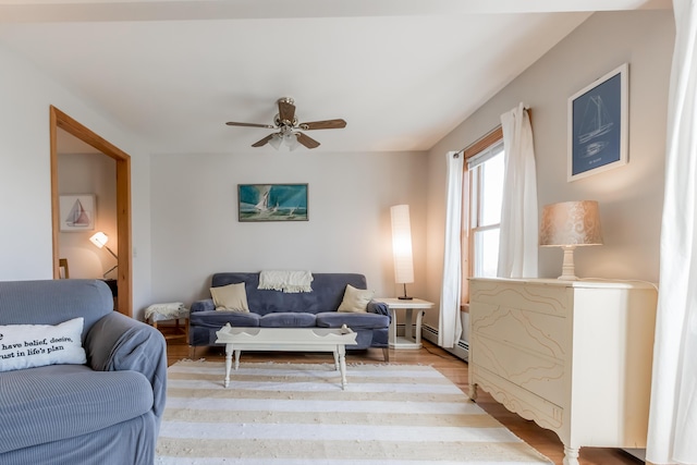 living room with a ceiling fan and light wood-type flooring