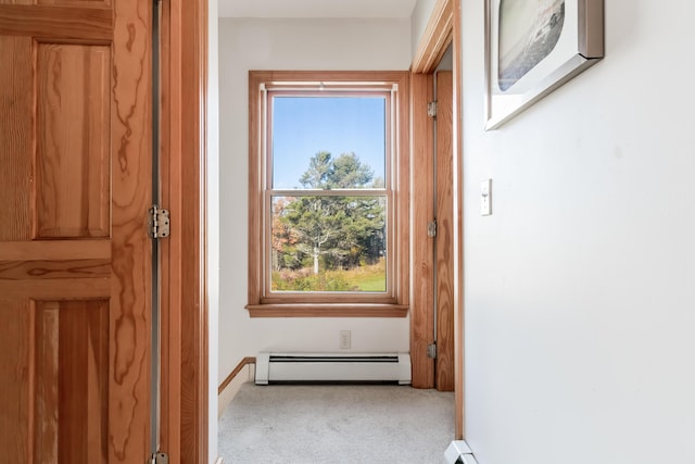 interior space featuring carpet floors, baseboards, and baseboard heating