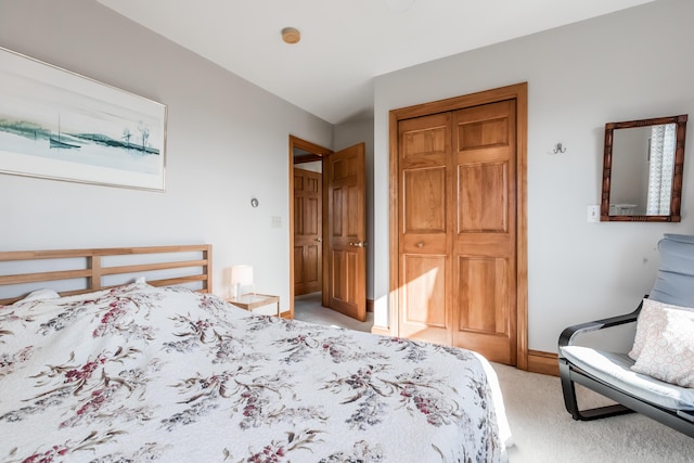 bedroom featuring light carpet and a closet