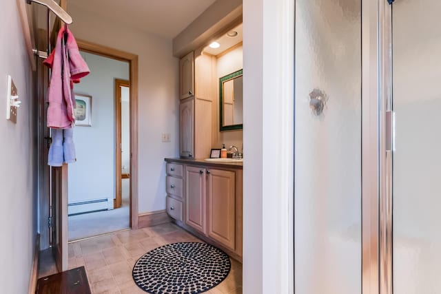full bath with vanity, baseboards, baseboard heating, and a stall shower