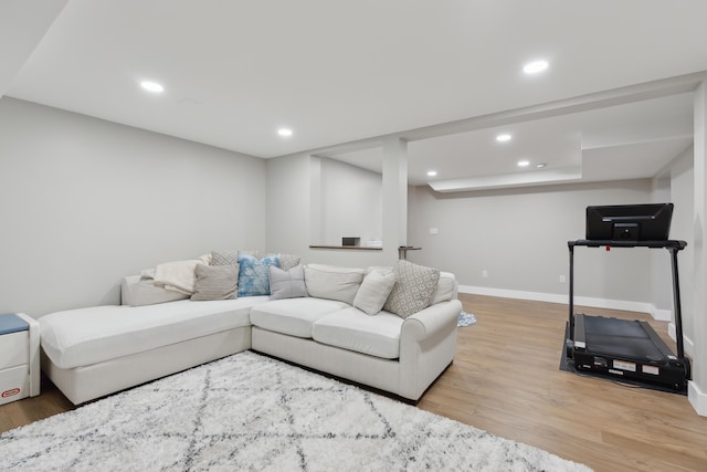 living room with recessed lighting, baseboards, and light wood-style flooring
