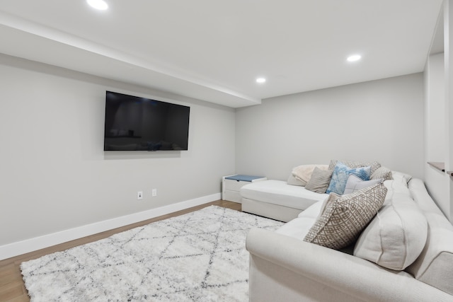 living room with recessed lighting, baseboards, and wood finished floors