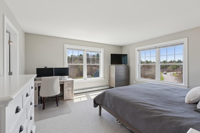 bedroom featuring multiple windows, baseboard heating, and light colored carpet