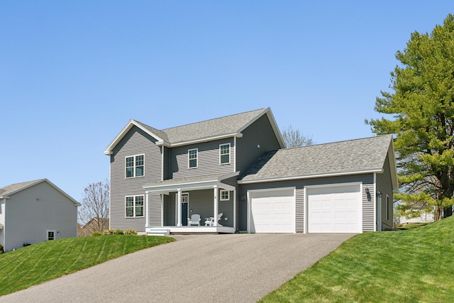traditional-style home featuring a shingled roof, an attached garage, a front lawn, aphalt driveway, and a porch