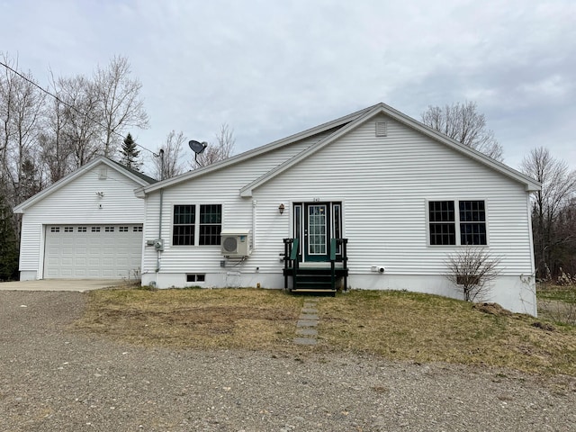 ranch-style house featuring ac unit, an attached garage, and driveway