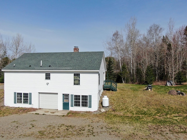 242 Bottle Lake Rd, Springfield, ME 04487 - back of property featuring roof with shingles, a yard, and a chimney