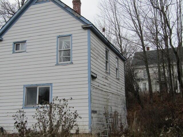 view of property exterior featuring a chimney