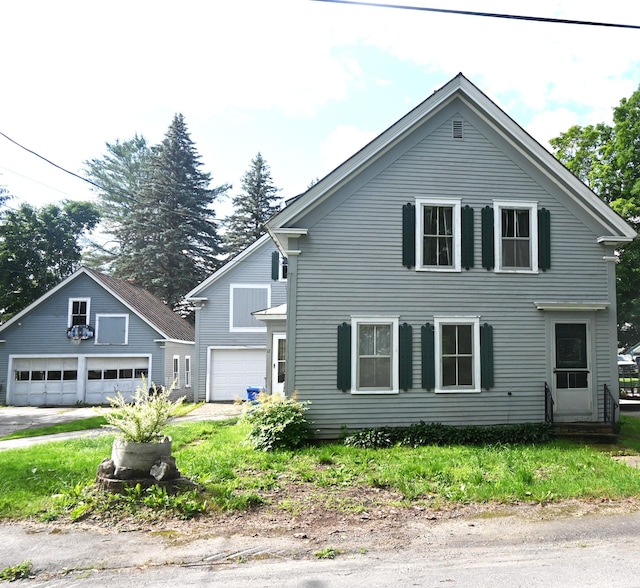 12 Preble St, Bingham, ME 04920 - view of front of home featuring a detached garage and an outbuilding