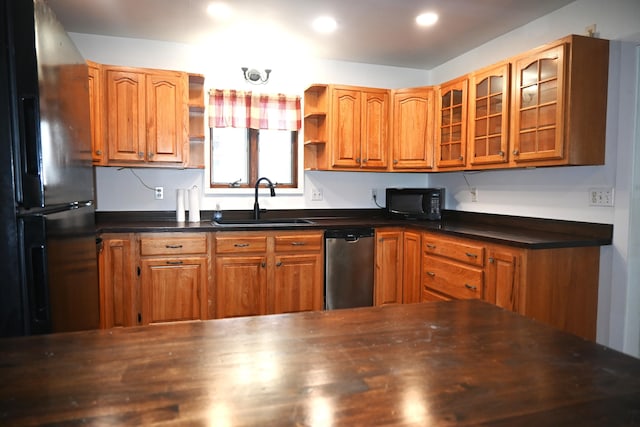 12 Preble St, Bingham, ME 04920 - kitchen with black appliances, open shelves, brown cabinets, dark countertops, and glass insert cabinets