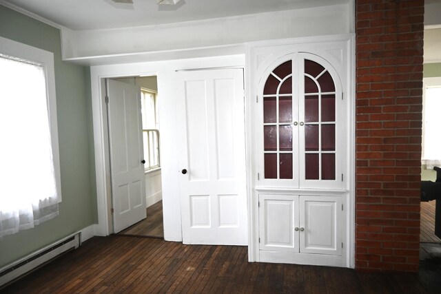 12 Preble St, Bingham, ME 04920 - empty room with a baseboard heating unit and dark wood finished floors