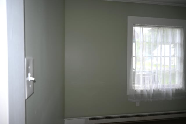 12 Preble St, Bingham, ME 04920 - spare room featuring baseboard heating and crown molding