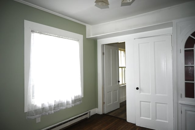 12 Preble St, Bingham, ME 04920 - unfurnished bedroom with a baseboard radiator, multiple windows, dark wood finished floors, and a closet