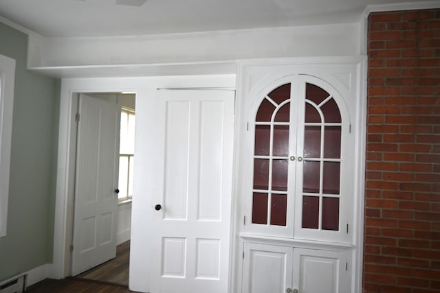 12 Preble St, Bingham, ME 04920 - detailed view of a baseboard heating unit and wood finished floors