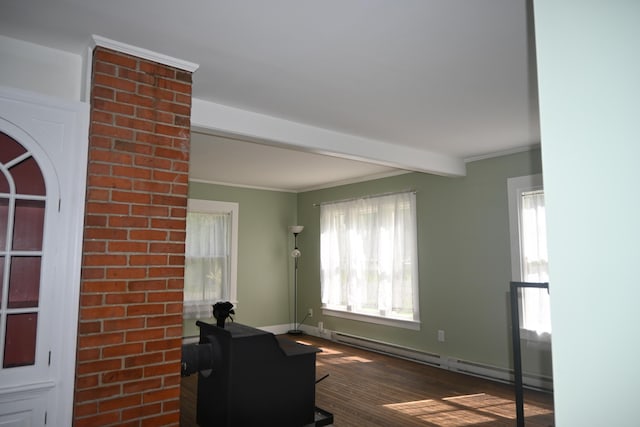 12 Preble St, Bingham, ME 04920 - living area with a baseboard heating unit, healthy amount of natural light, wood finished floors, beamed ceiling, and ornamental molding