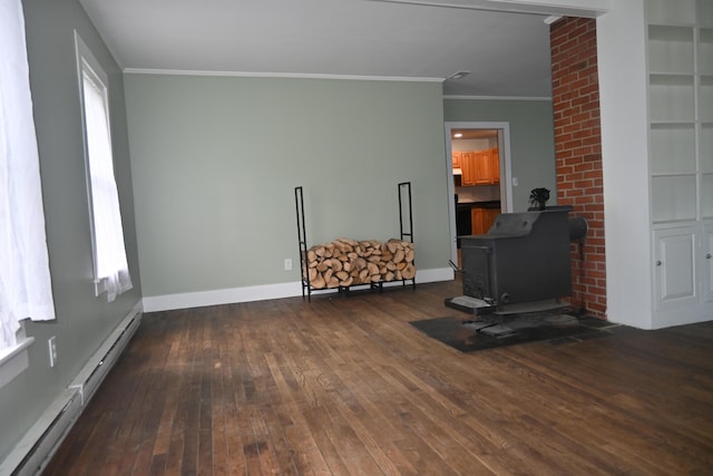 12 Preble St, Bingham, ME 04920 - living area with a wood stove, a baseboard heating unit, crown molding, and dark wood finished floors