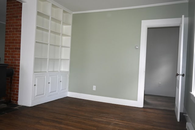 12 Preble St, Bingham, ME 04920 - unfurnished room featuring a wood stove, dark wood-style floors, crown molding, and a baseboard radiator