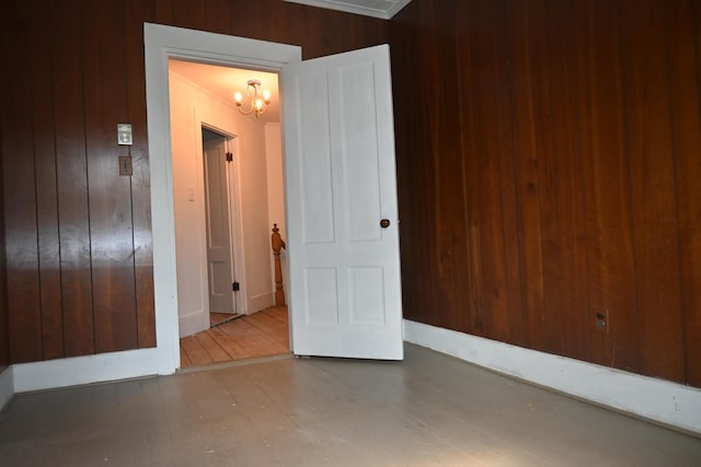 12 Preble St, Bingham, ME 04920 - spare room featuring wood walls and a chandelier