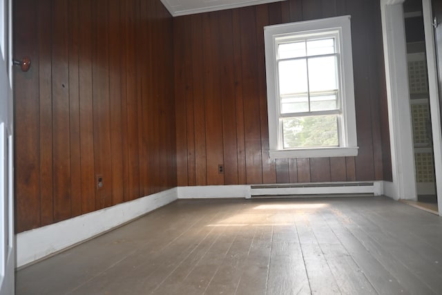 12 Preble St, Bingham, ME 04920 - spare room with a baseboard heating unit, healthy amount of natural light, hardwood / wood-style flooring, and wood walls