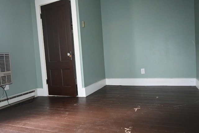 12 Preble St, Bingham, ME 04920 - empty room with hardwood / wood-style floors and a baseboard heating unit