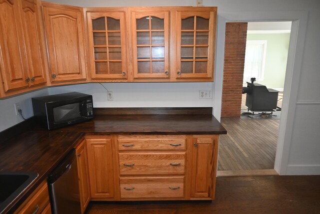 12 Preble St, Bingham, ME 04920 - kitchen featuring black microwave, dark countertops, stainless steel dishwasher, glass insert cabinets, and dark wood-type flooring