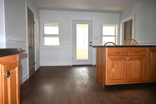 12 Preble St, Bingham, ME 04920 - kitchen with dark wood-type flooring, brown cabinets, and dark countertops